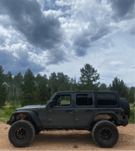 Side view of the rented Jeep off the side of the ATV trail.